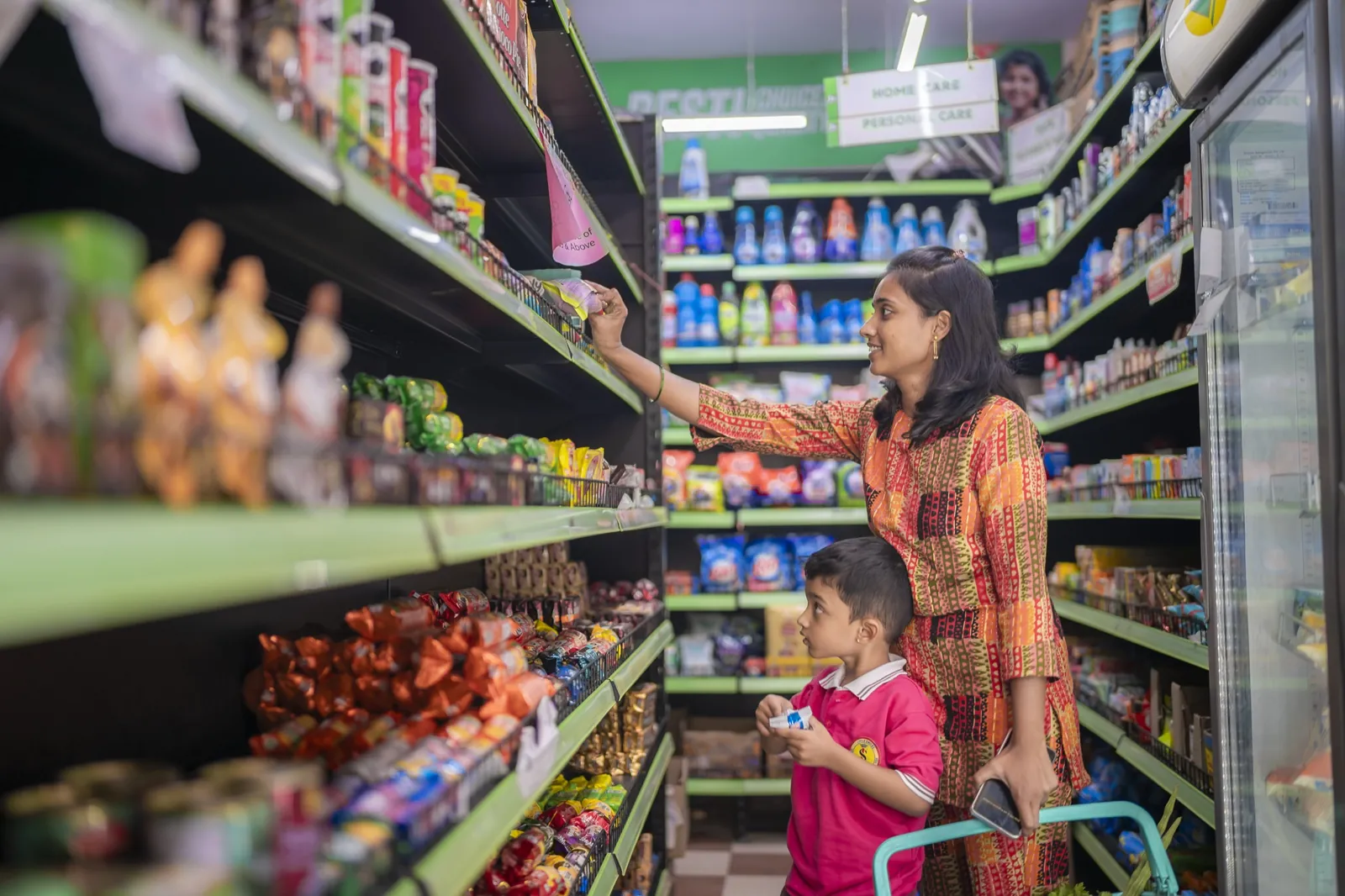 A mother and son shopping the aisle of a J24 store