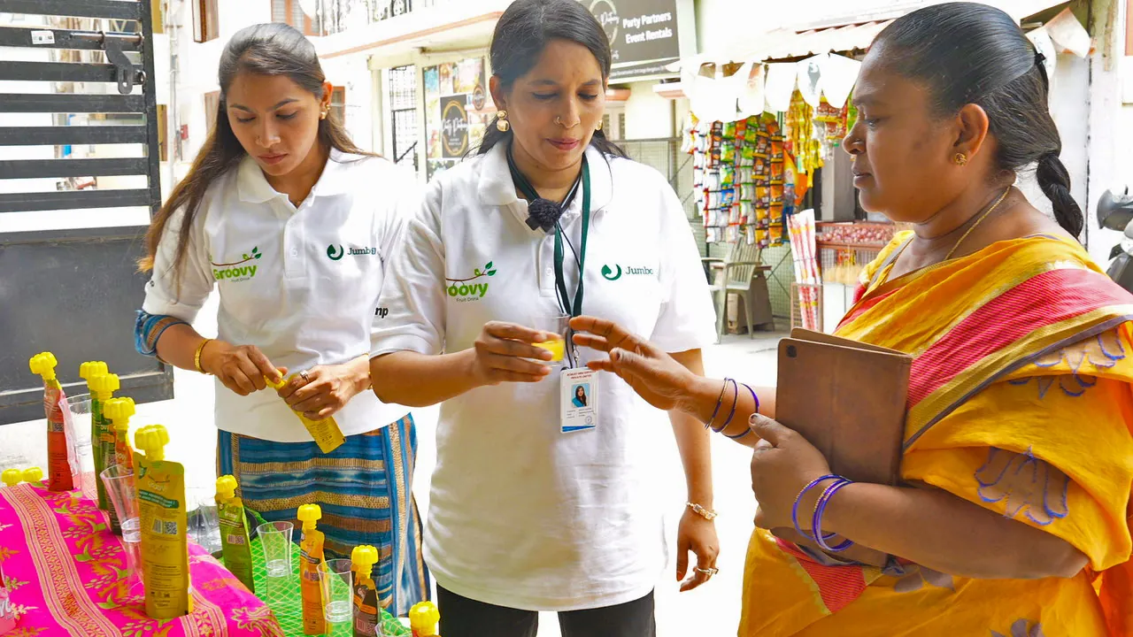 Brand promoters offering a product sample outside a J24 store